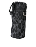 Sac Dolce & Gabbana noir à motif léopard rond, sac à main fin et élégant avec porte-bouteille intégré.