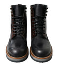 Bottes de combat en cuir noir Dolce & Gabbana, style militaire, chaussures robustes et élégantes pour femmes et hommes.