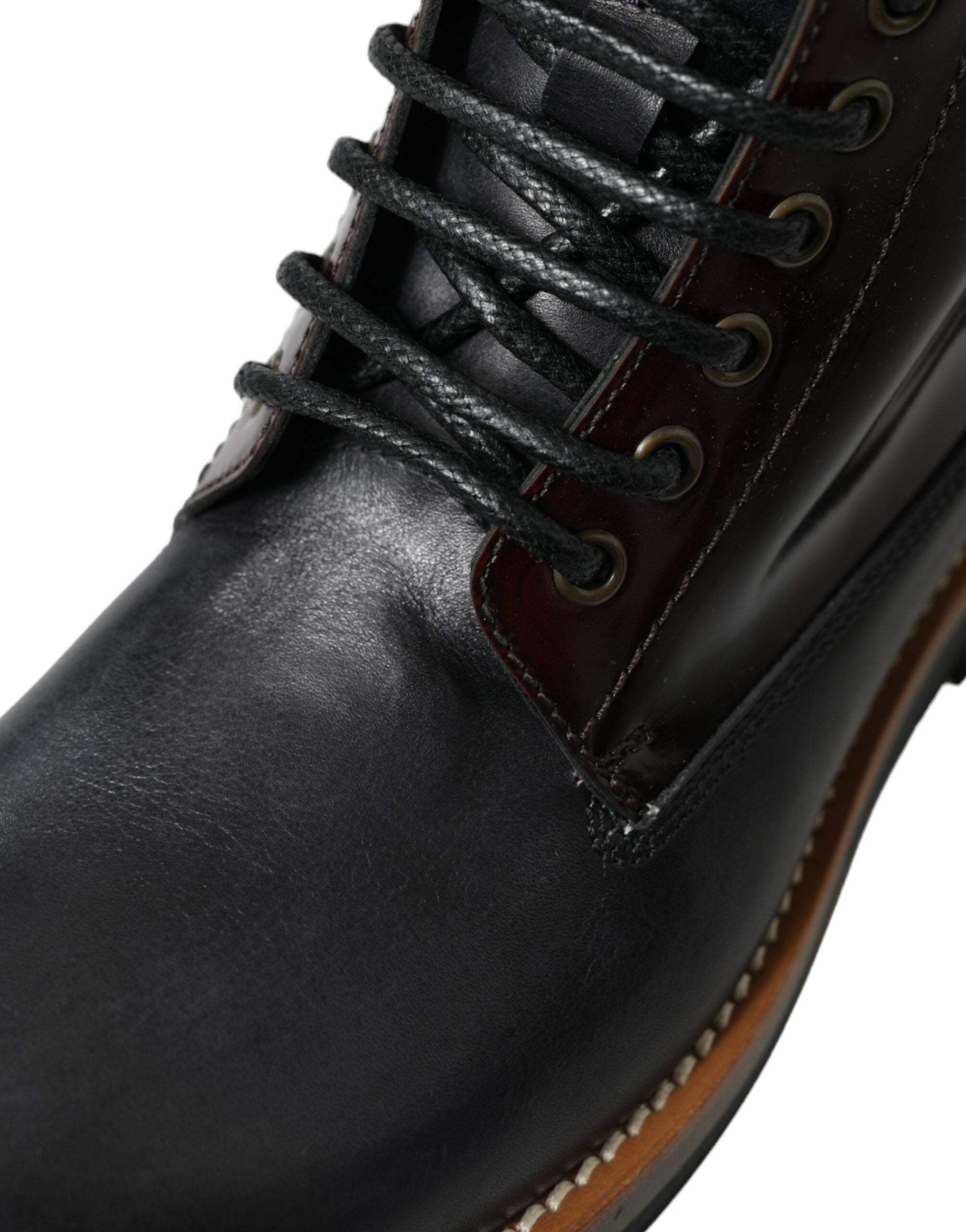 Bottes de combat en cuir noir Dolce & Gabbana, style militaire, avec lacets et design robuste.