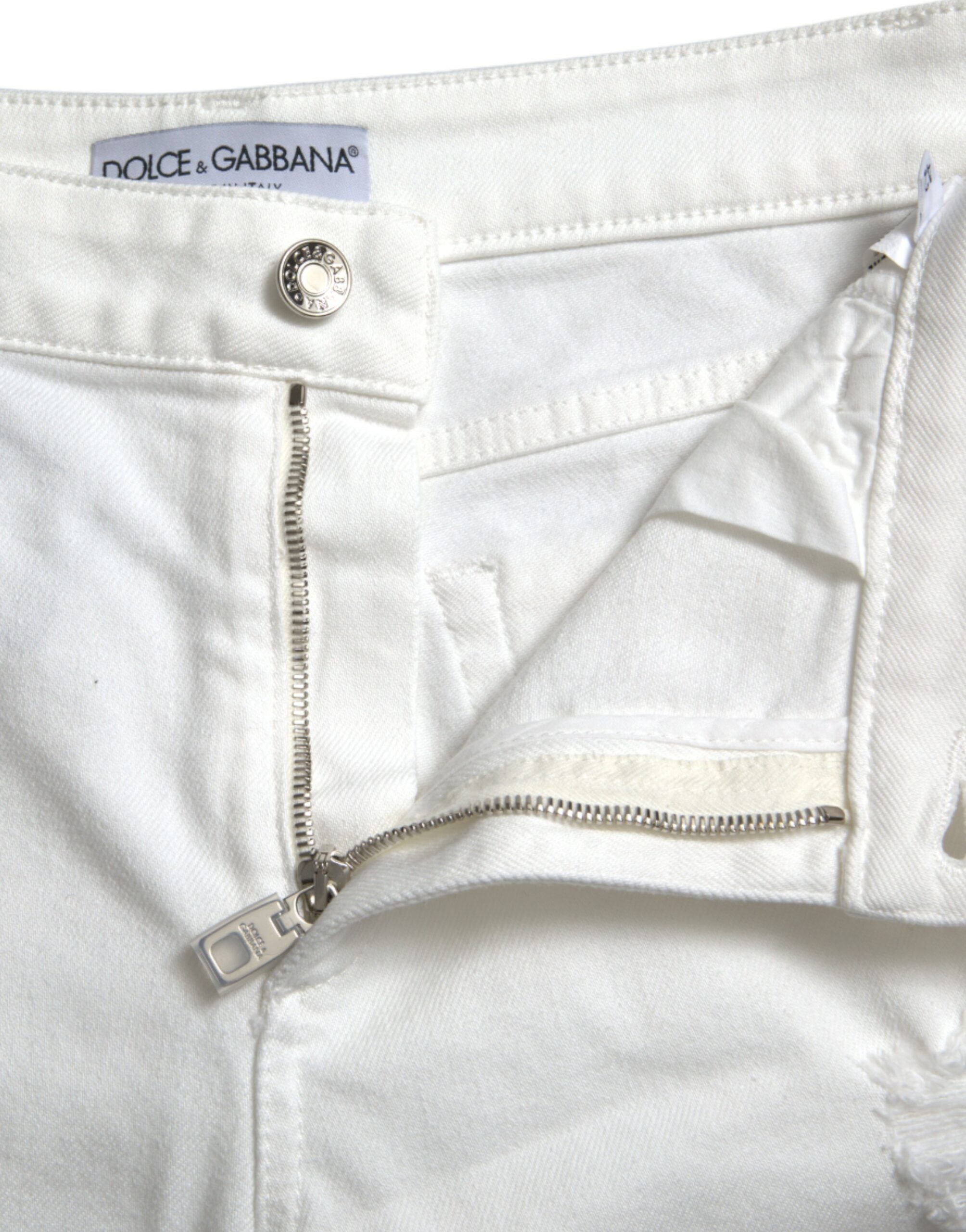 Jeans en jean blanc Dolce & Gabbana, coupe cropped, taille haute, avec jambes larges et couture visible, mode élégante.