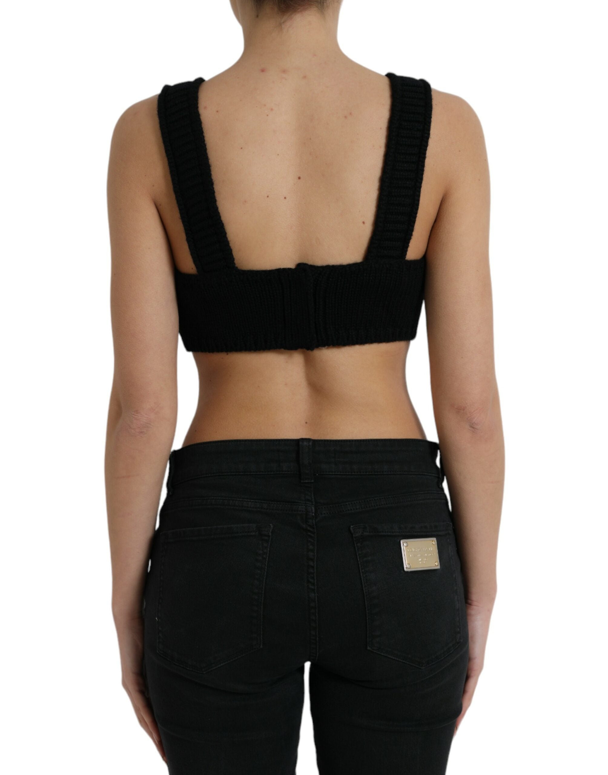 Top bustier en cachemire noir Dolce & Gabbana, coupe courte et décolleté en V, porté avec détails élégants.