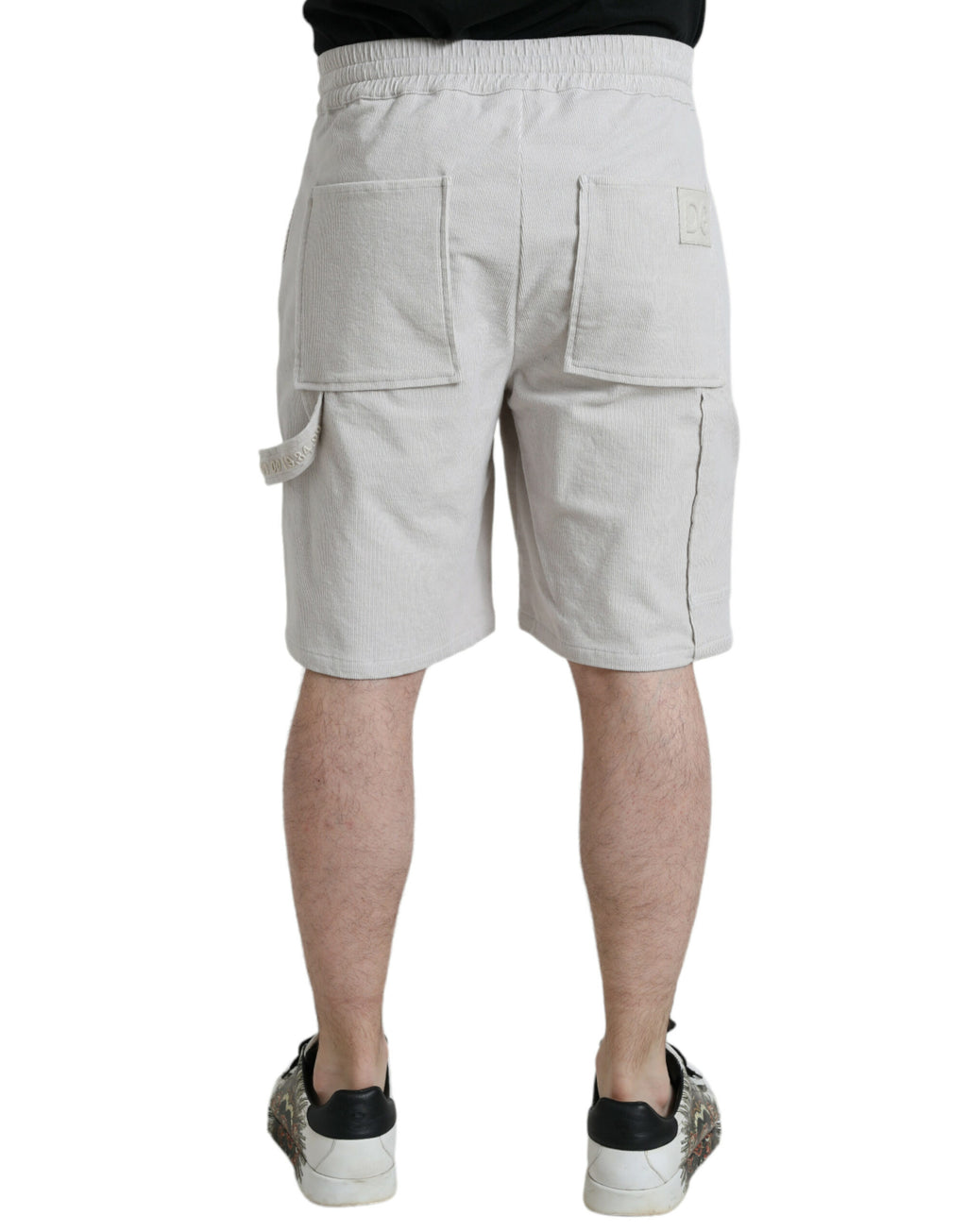 Shorts bermuda en coton beige Dolce & Gabbana avec logo en corduroy, style élégant et décontracté.