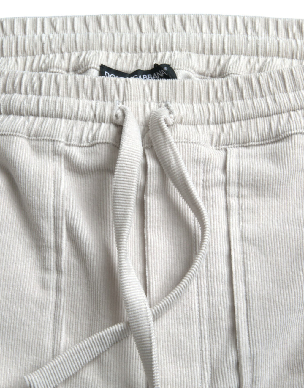 Shorts bermuda en coton beige avec logo Dolce & Gabbana, en tissu côtelé, pour un style élégant et décontracté.
