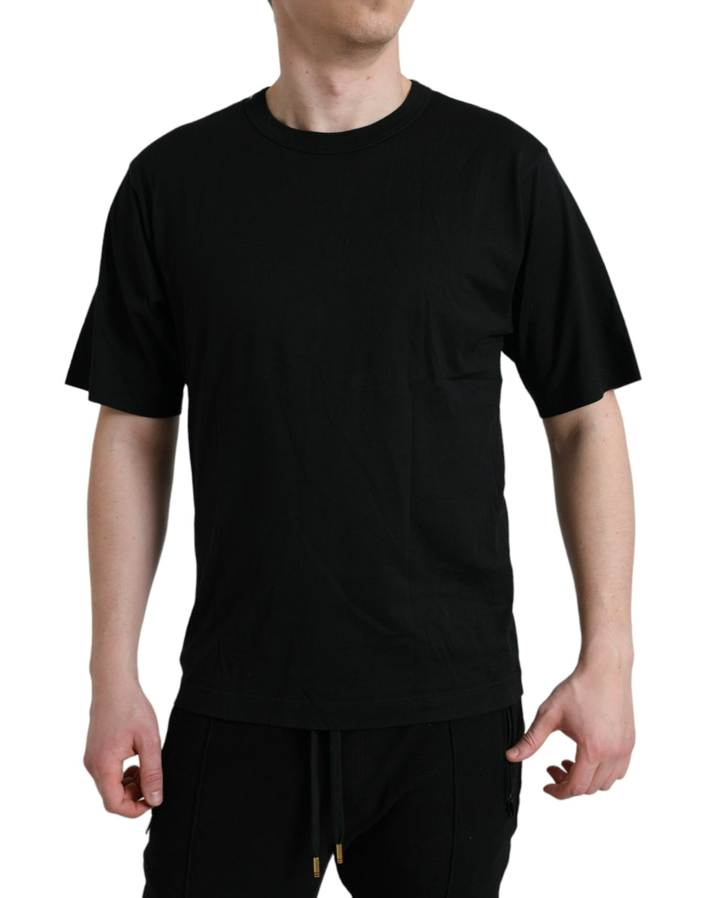 T-shirt noir Dolce & Gabbana à logo embossé, col rond et manches courtes, vue de face.