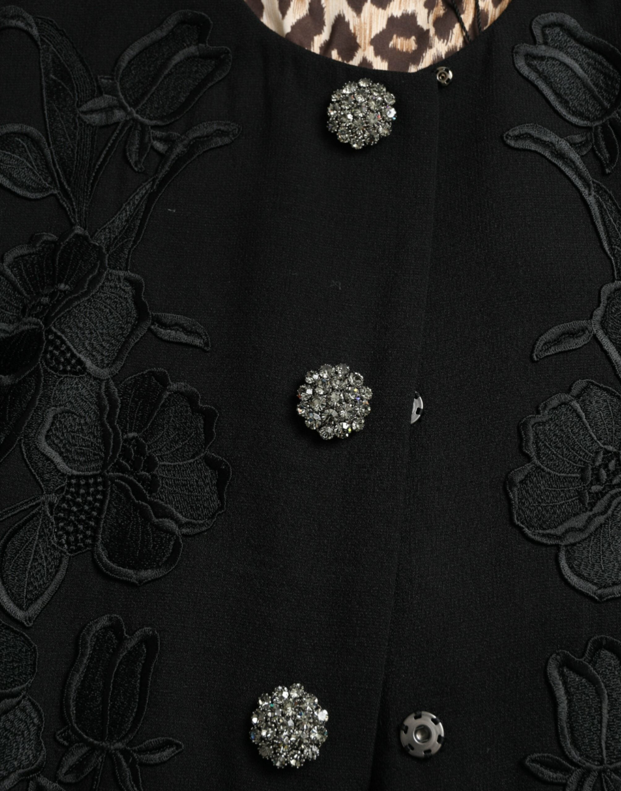 Veste en laine noire Dolce & Gabbana avec motifs floraux, boutons décoratifs et détails embellis.