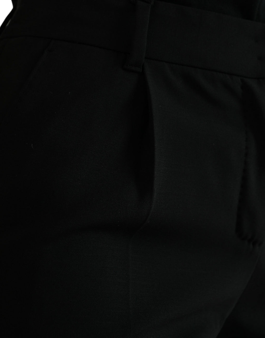 Pantalon noir en laine à taille moyenne et coupe tapered par Dolce & Gabbana, visible avec détails de couture.