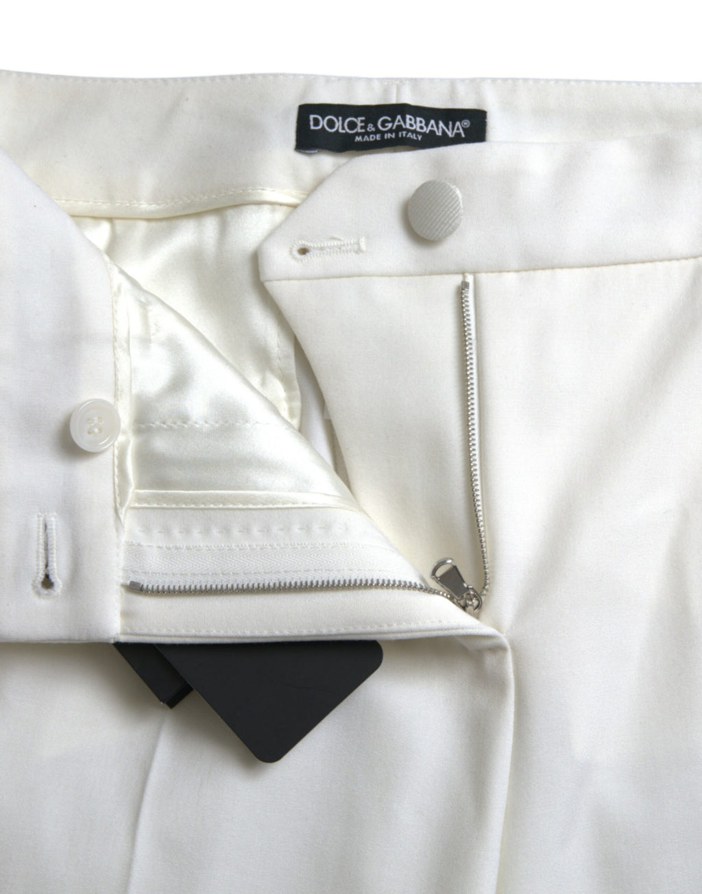 Pantalons en laine blanche Dolce & Gabbana, taille moyenne, coupe tapered, vue de face sur un modèle.