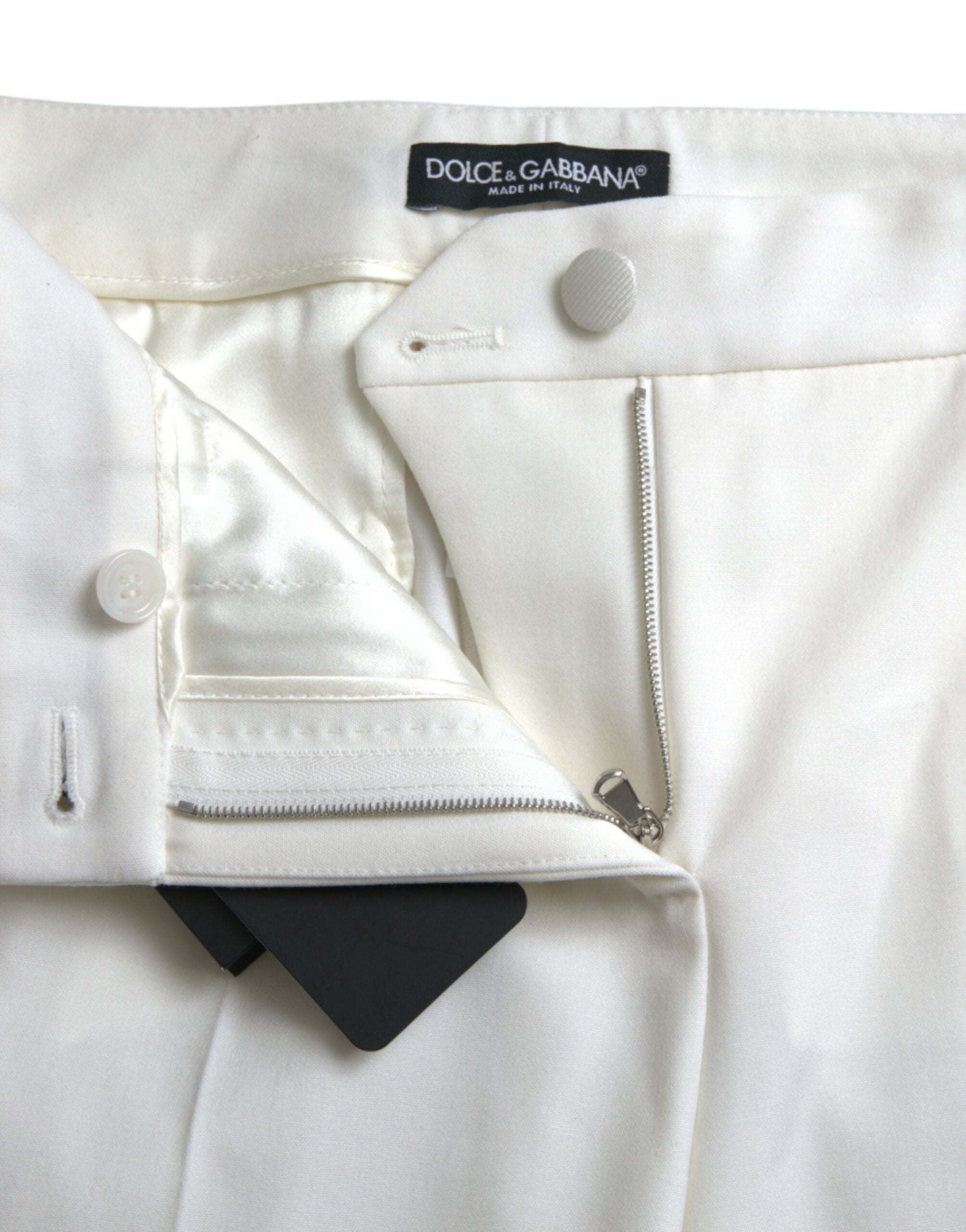 Pantalons en laine blanche Dolce & Gabbana, taille moyenne, coupe tapered, vue de face sur un modèle.
