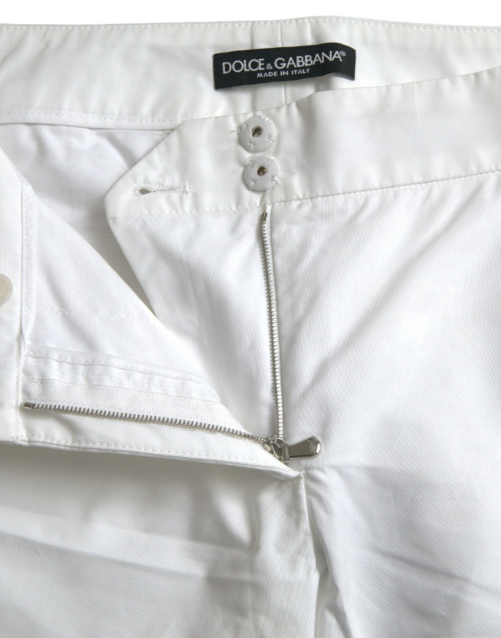 Pantalons cropped en coton blanc Dolce & Gabbana avec découpes à la taille moyenne, mode élégante et tendance.
