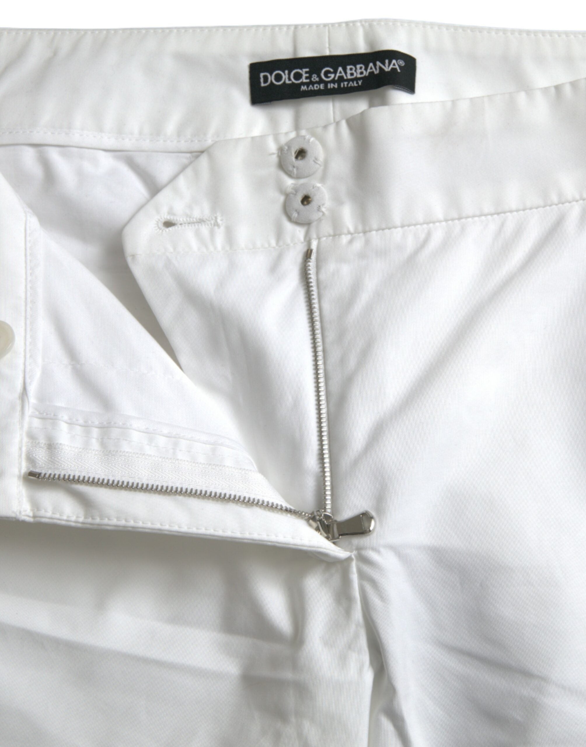 Pantalons cropped en coton blanc Dolce & Gabbana avec découpes à la taille moyenne, mode élégante et tendance.