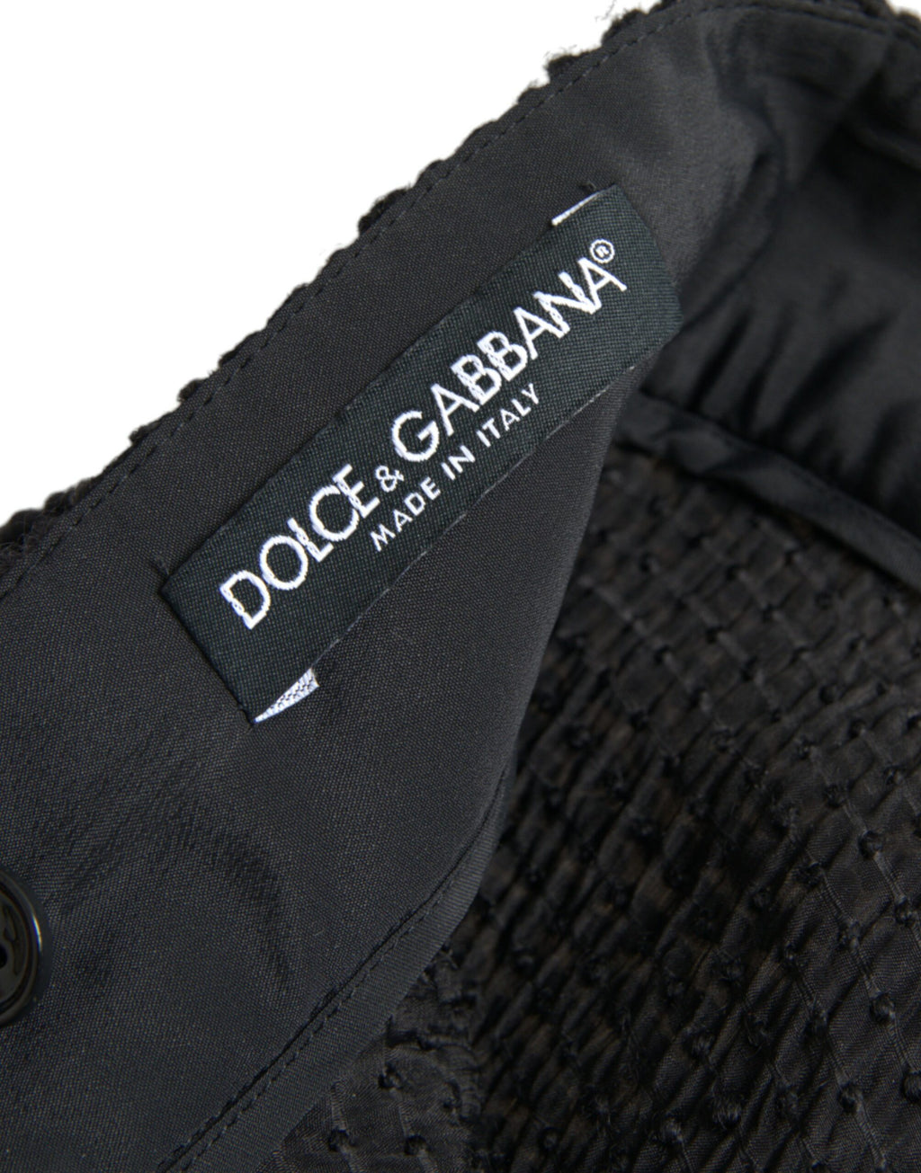 Jupe noire à taille haute et coupe évasée, longueur genou, de la marque Dolce & Gabbana, vue de face.