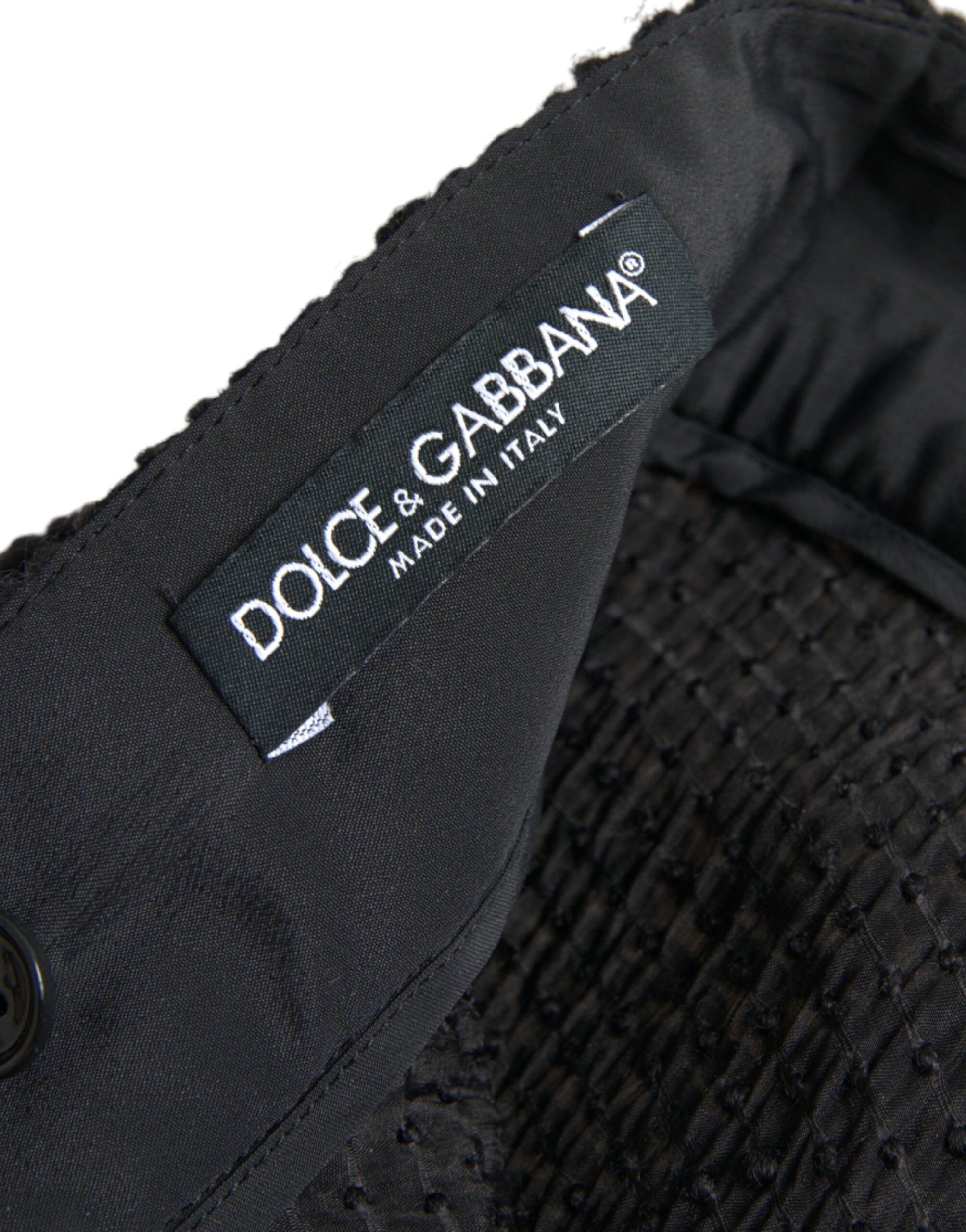 Jupe noire à taille haute et coupe évasée, longueur genou, de la marque Dolce & Gabbana, vue de face.