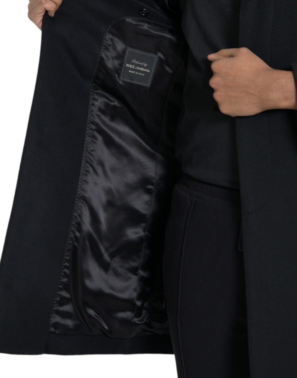 Manteau trench noir à un seul rang de boutons de la marque Dolce & Gabbana, porté sur un mannequin.