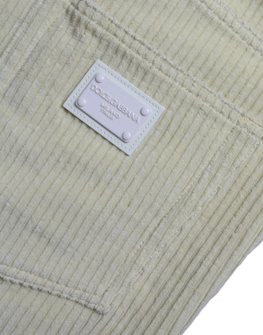 Jeans skinny en denim jaune Dolce & Gabbana avec logo en plaque en velours côtelé, style élégant et tendance.