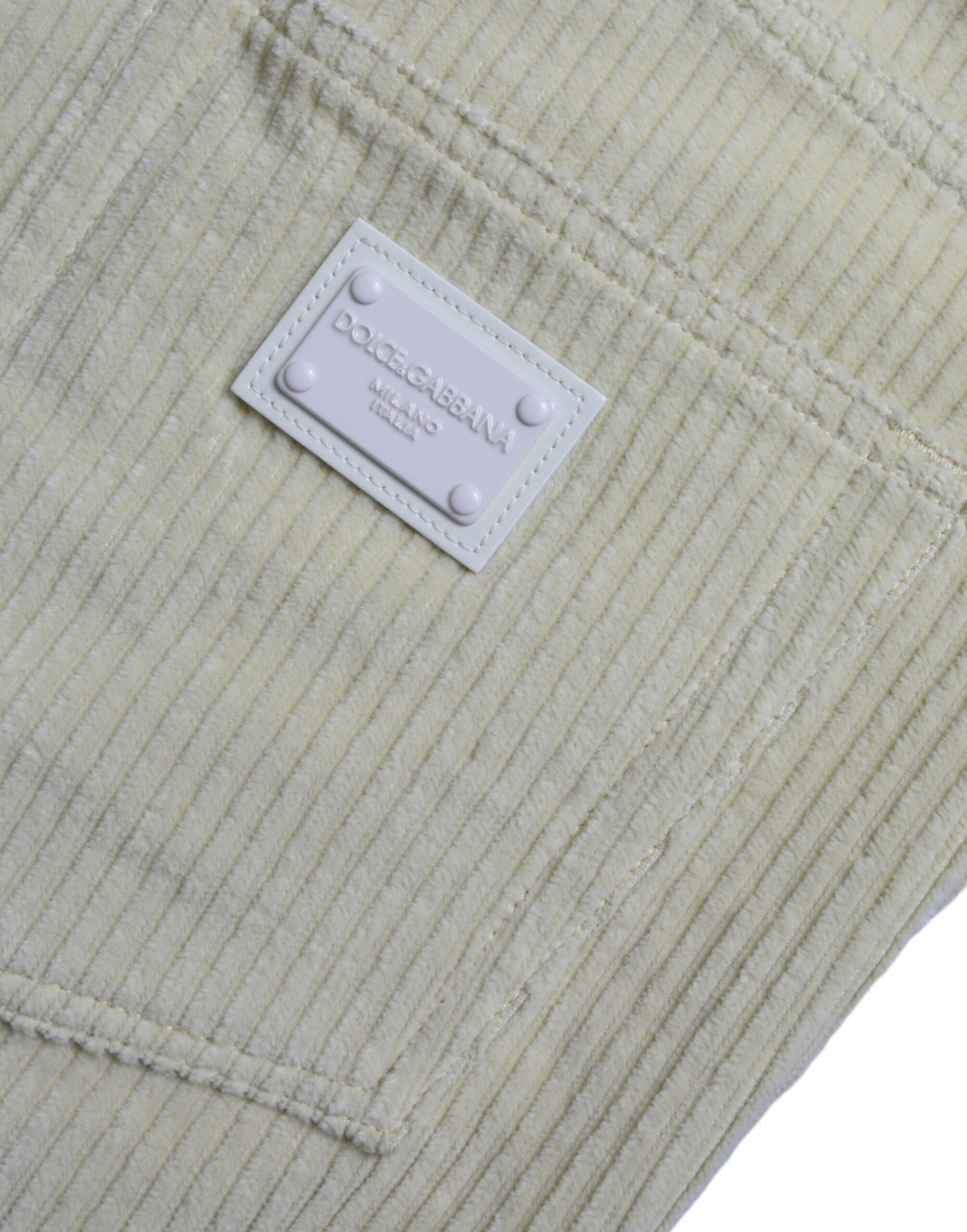 Jeans skinny en denim jaune Dolce & Gabbana avec logo en plaque en velours côtelé, style élégant et tendance.