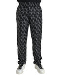 Pantalons en soie noirs à motif fer à cheval Dolce & Gabbana, élégants et sophistiqués, visibles en gros plan.