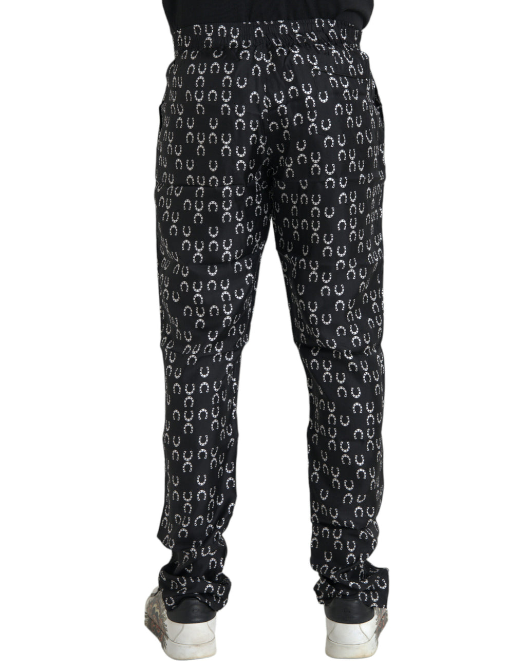 Pantalons en soie noirs Dolce & Gabbana avec motif fer à cheval, coupe élégante et détails sophistiqués.