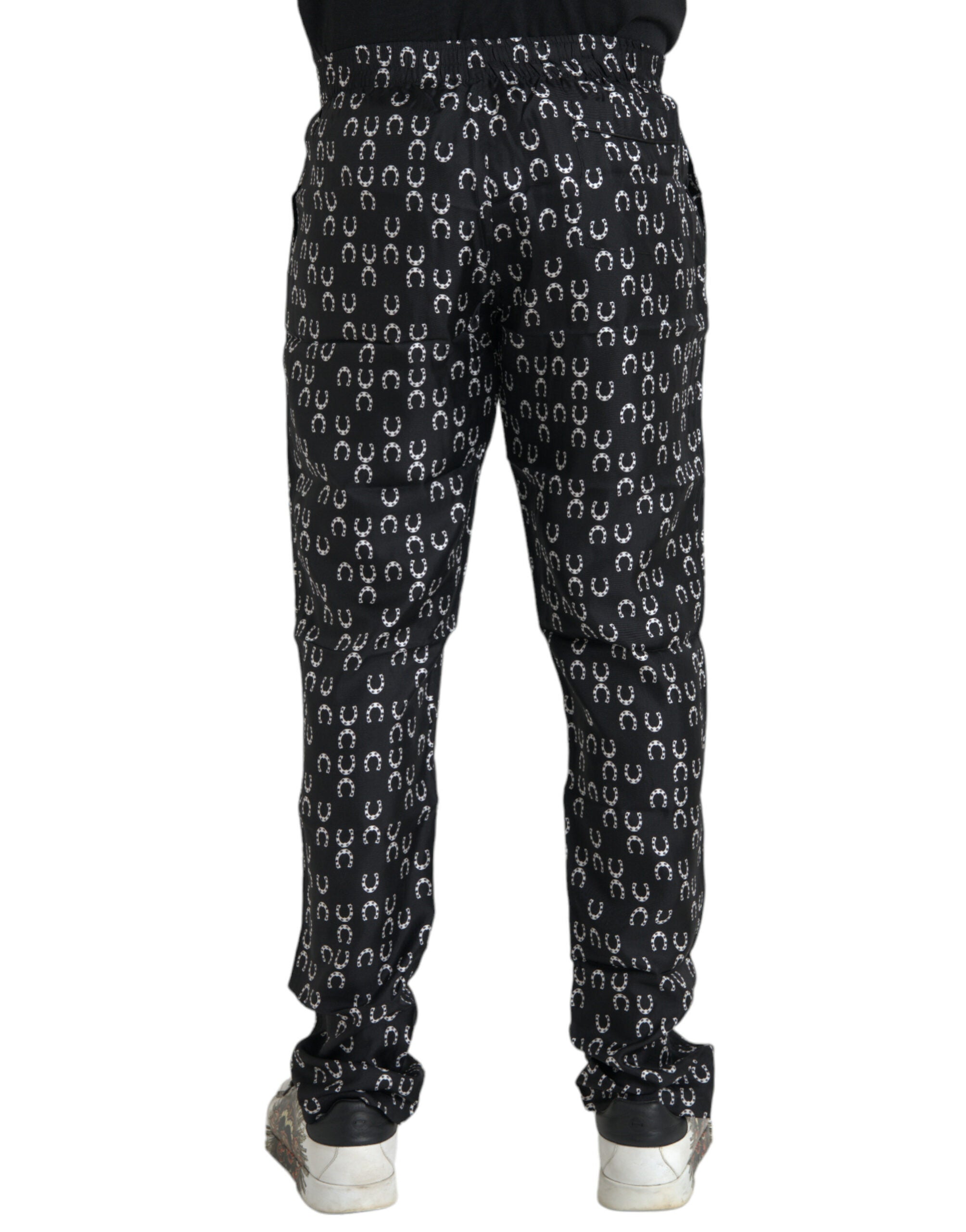 Pantalons en soie noirs Dolce & Gabbana avec motif fer à cheval, coupe élégante et détails sophistiqués.
