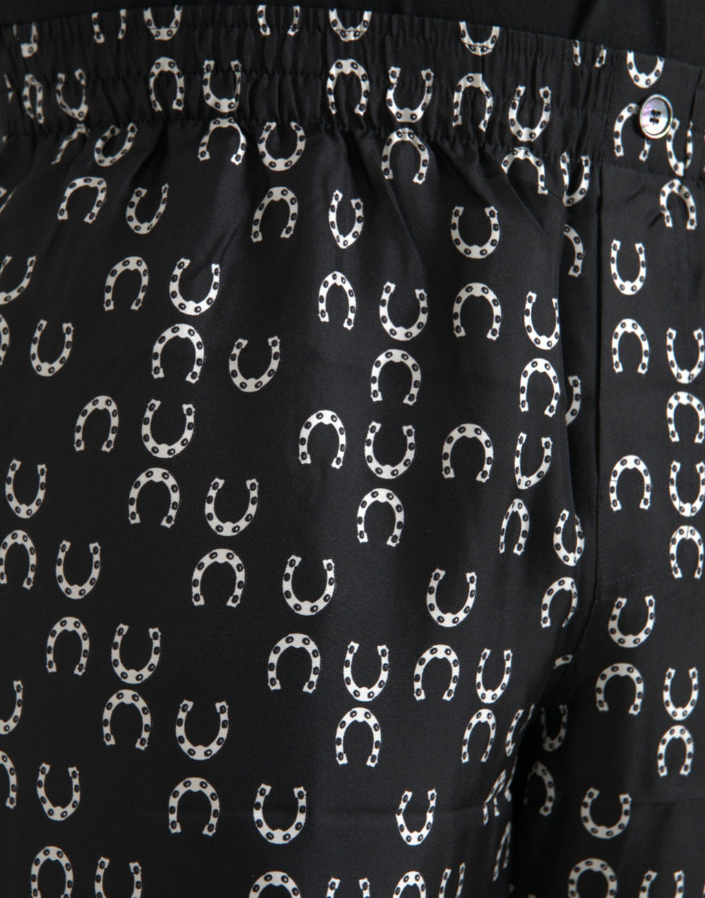Pantalons en soie noire avec motif fer à cheval Dolce & Gabbana, design élégant et sophistiqué pour femmes.