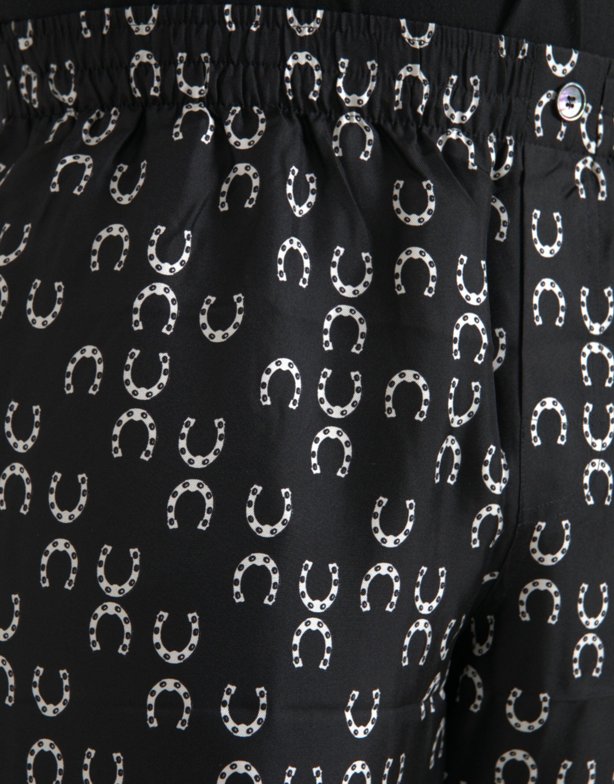 Pantalons en soie noire avec motif fer à cheval Dolce & Gabbana, design élégant et sophistiqué pour femmes.