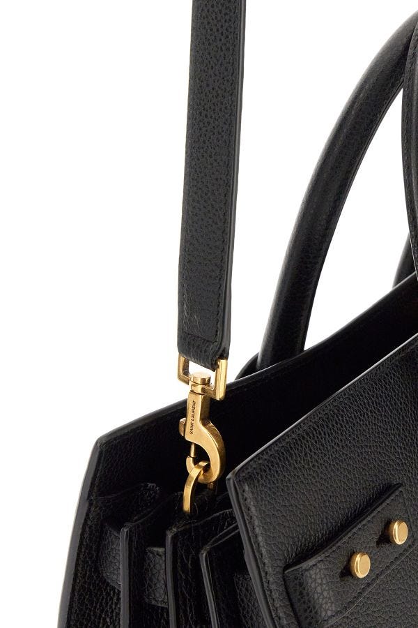 Sac à main Saint Laurent Sac De Jour en cuir de veau noir, avec poignées en cuir et logo discret sur le devant.