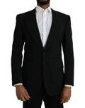 Manteau noir en laine Dolce & Gabbana, blazer à col cranté et coupe cintrée, vue de face sur fond neutre.