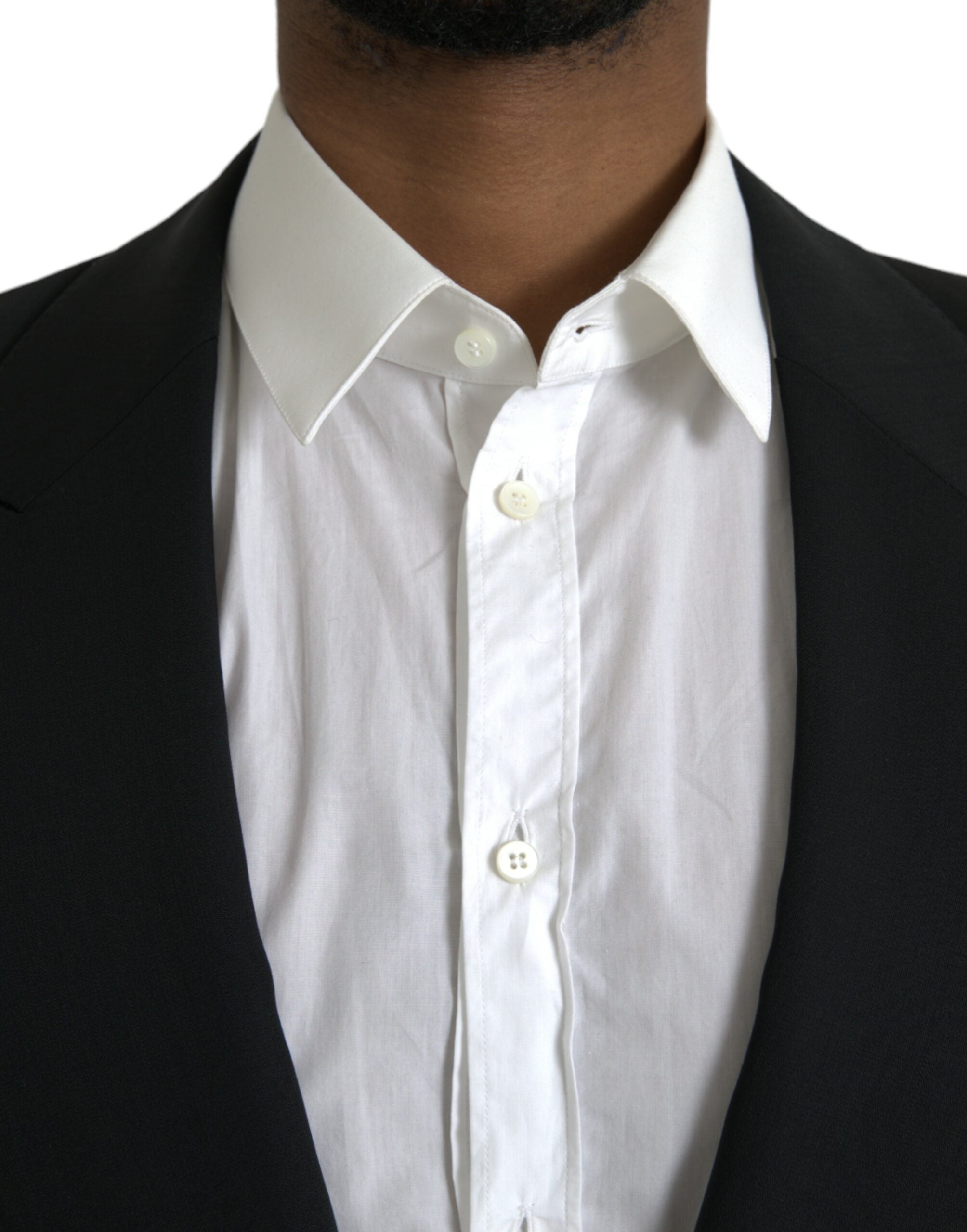 Manteau blazer noir en laine à col pointu, coupe simple boutonnage, signé Dolce & Gabbana, porté sur un mannequin.