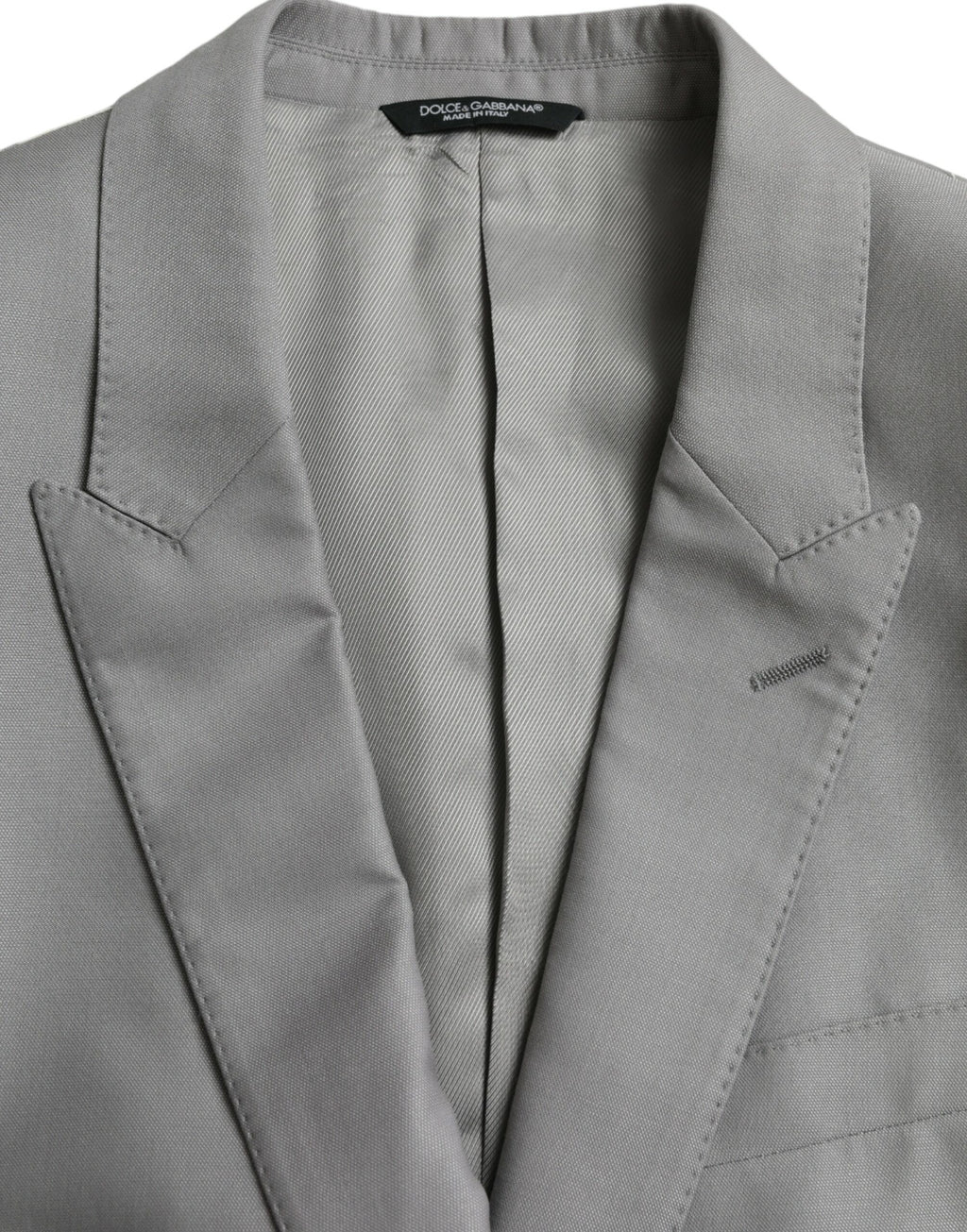 Manteau blazer en laine grise Dolce & Gabbana à col pointu et fermeture à un bouton, mode élégante et sophistiquée.