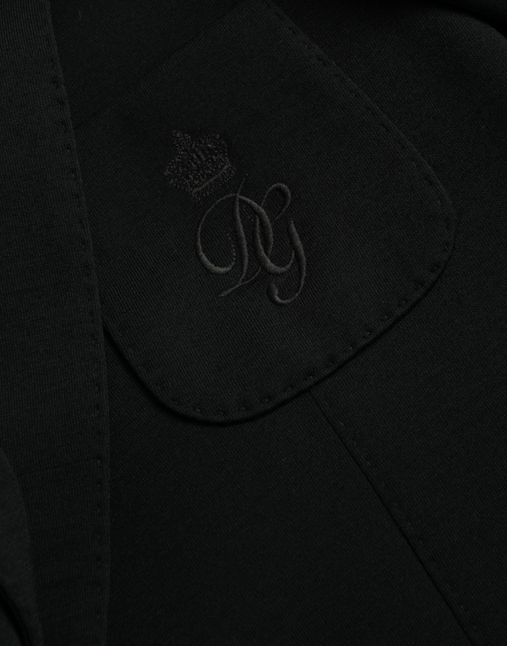 Manteau blazer noir en laine Dolce & Gabbana à col en V et fermeture croisée, style classique et élégant.