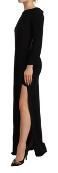 Robe longue noire à manches longues avec fente latérale, de la marque Dsquared², portée sur le sol, élégante et sophistiquée.