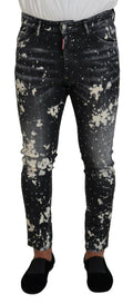 Jeans skinny en denim gris avec éclaboussures blanches de la marque Dsquared², visibles en détail sur le produit.