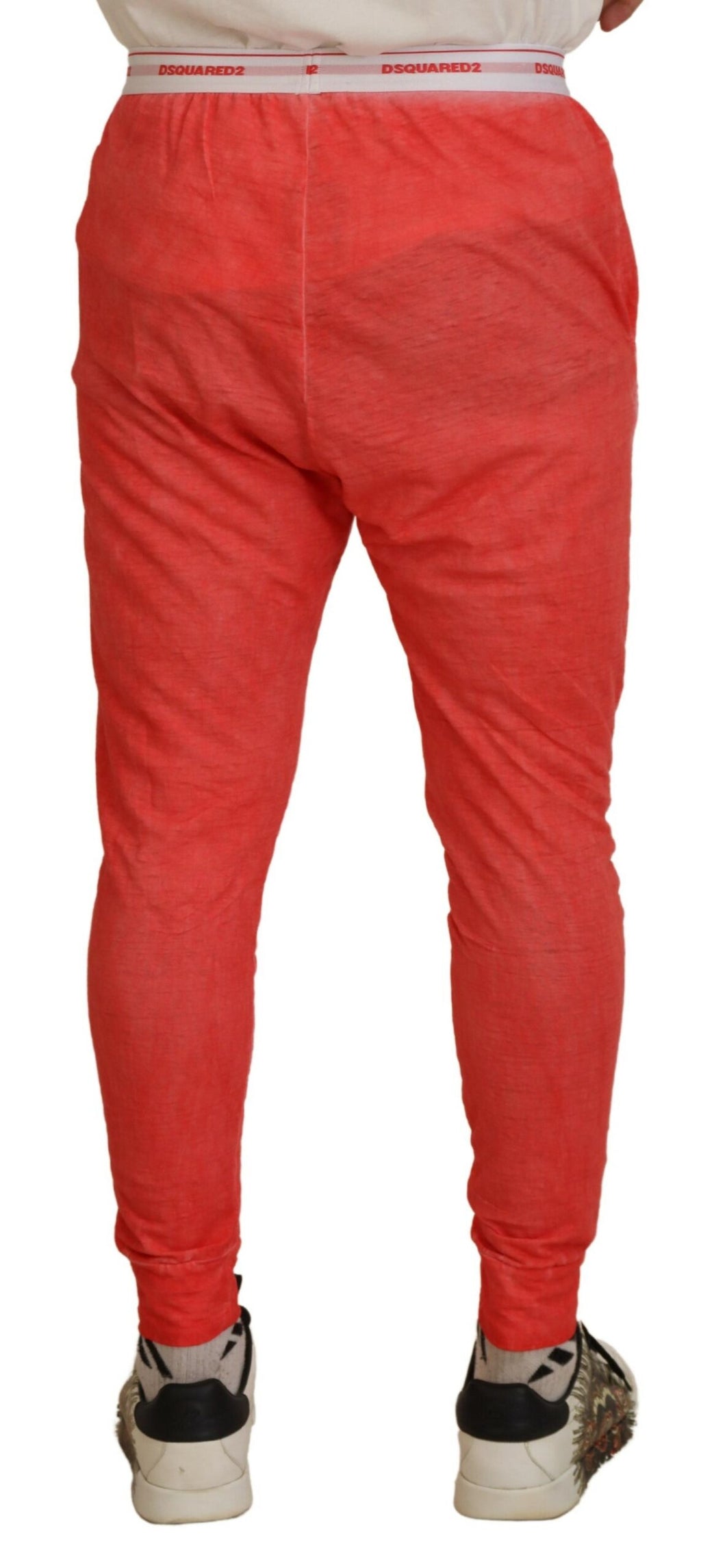 Pantalon homme Dsquared² en coton orange avec taille élastique et logo visible, design décontracté et moderne.