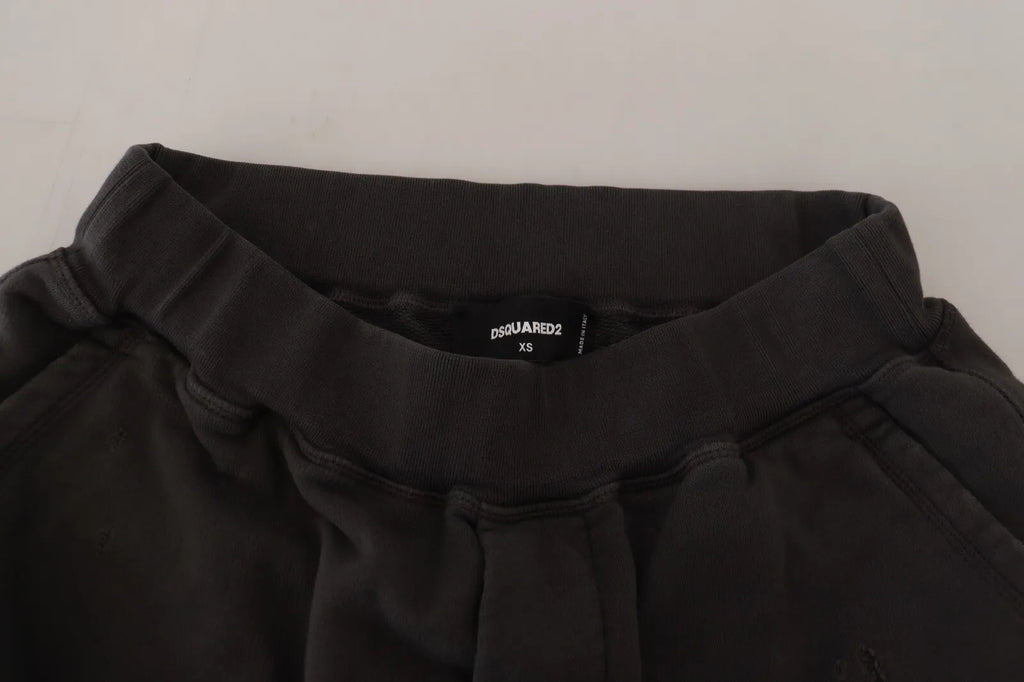 Shorts en coton noir Dsquared², coupe tapered à taille mi-haute avec déchirures et style décontracté, visible en image.