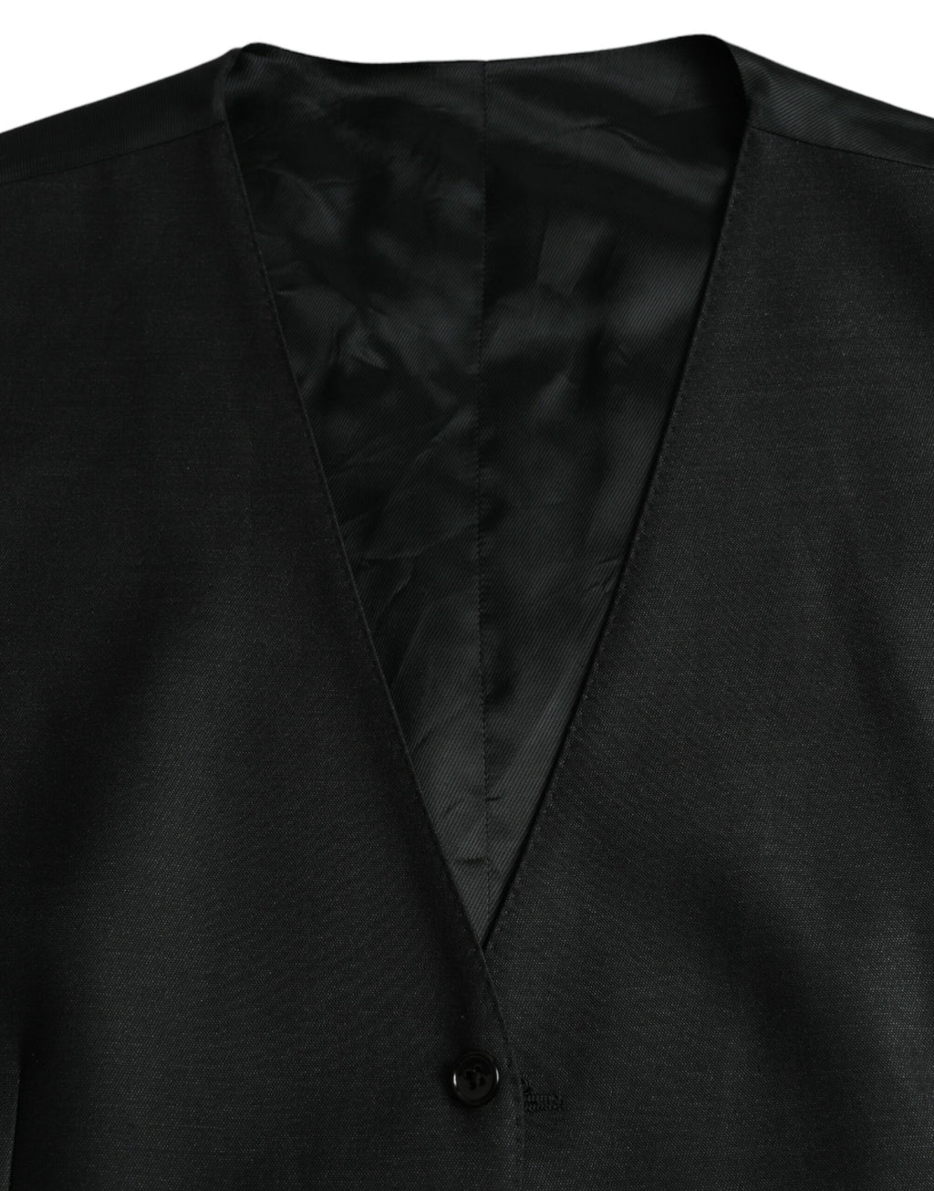 Robe-quepe en laine noire Dolce & Gabbana, veste formelle ajustée avec détails élégants, portée comme robe ou veste chic.
