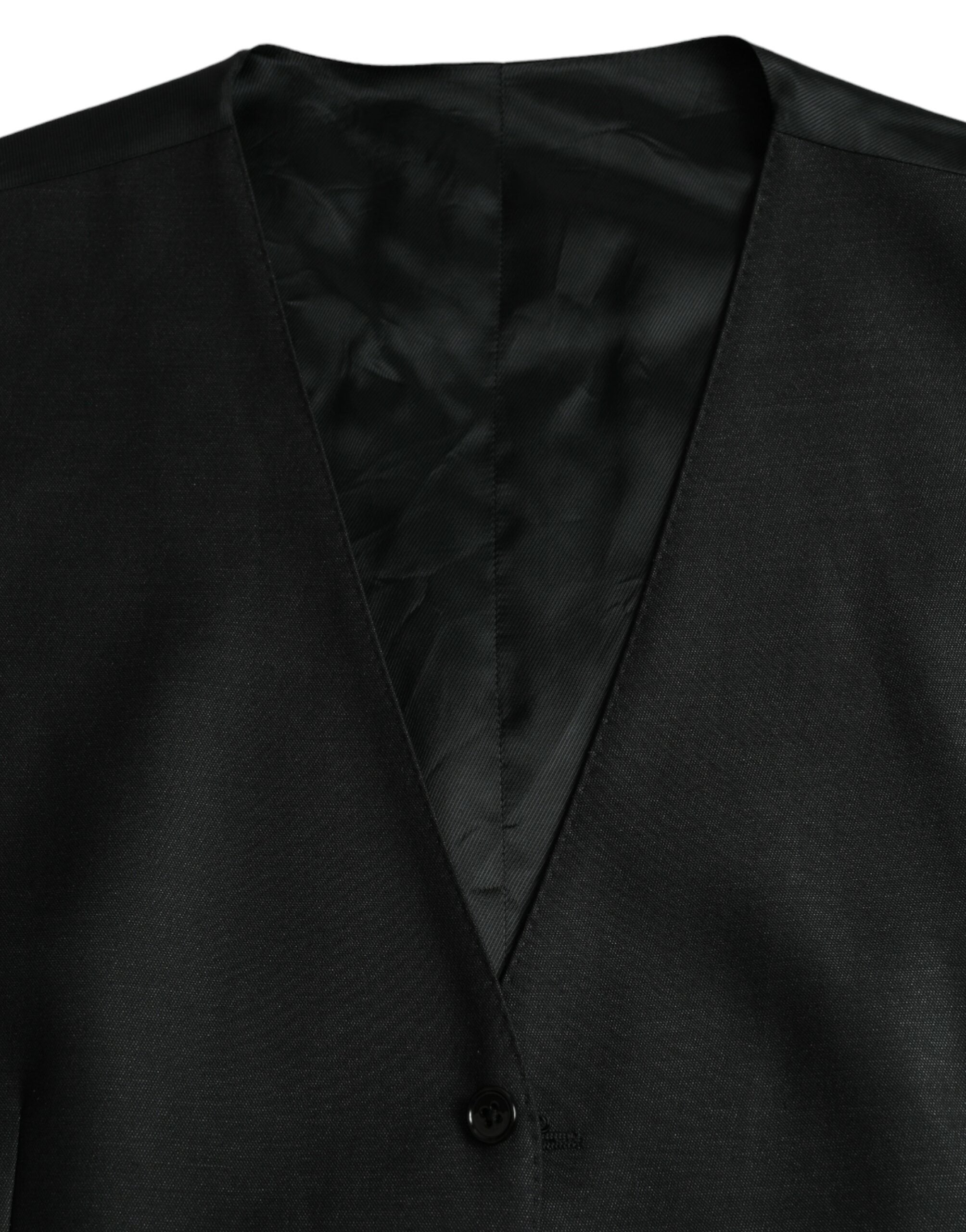 Robe-quepe en laine noire Dolce & Gabbana, veste formelle ajustée avec détails élégants, portée comme robe ou veste chic.