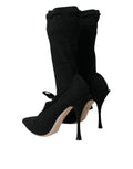 Chaussures Dolce & Gabbana, bottines noires à talons stilettos et mi-mollet, style élégant et sophistiqué.