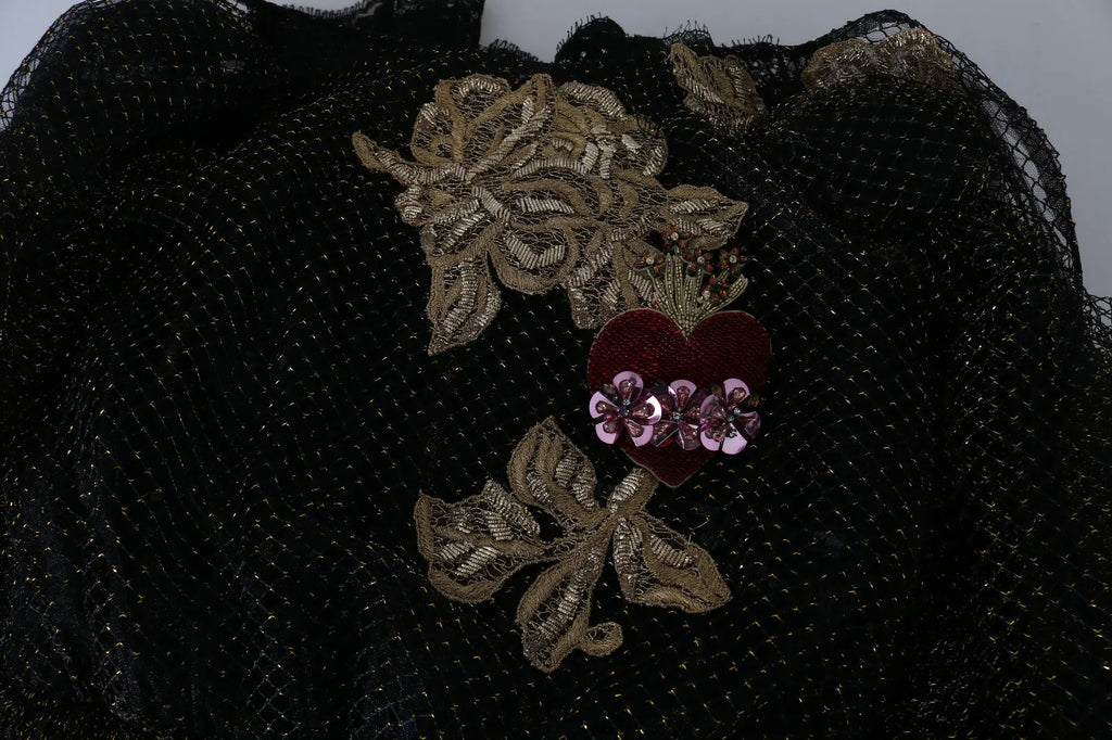 Robe en forme A Dolce & Gabbana noire avec cristaux dorés et cœur, élégante et sophistiquée, vue de face sur un fond neutre.