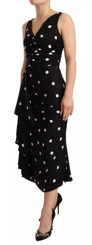 Robe midi en soie noire à pois Dolce & Gabbana avec décolleté en V, coupe ajustée et élégante.