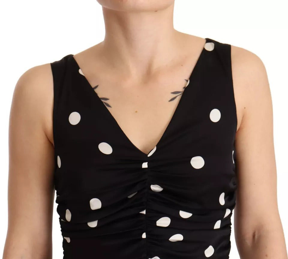 Robe midi noire en soie à pois Dolce & Gabbana avec décolleté en V, coupe ajustée et élégante.