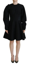 Robe courte en coton noire Dolce & Gabbana à manches longues et coupe A-line, portée élégante et moderne.