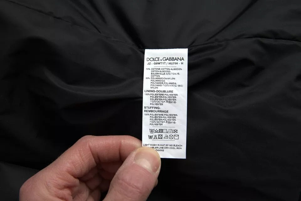 Veste bomber noire en coton Dolce & Gabbana avec capuche et logo, vue de face sur fond blanc.