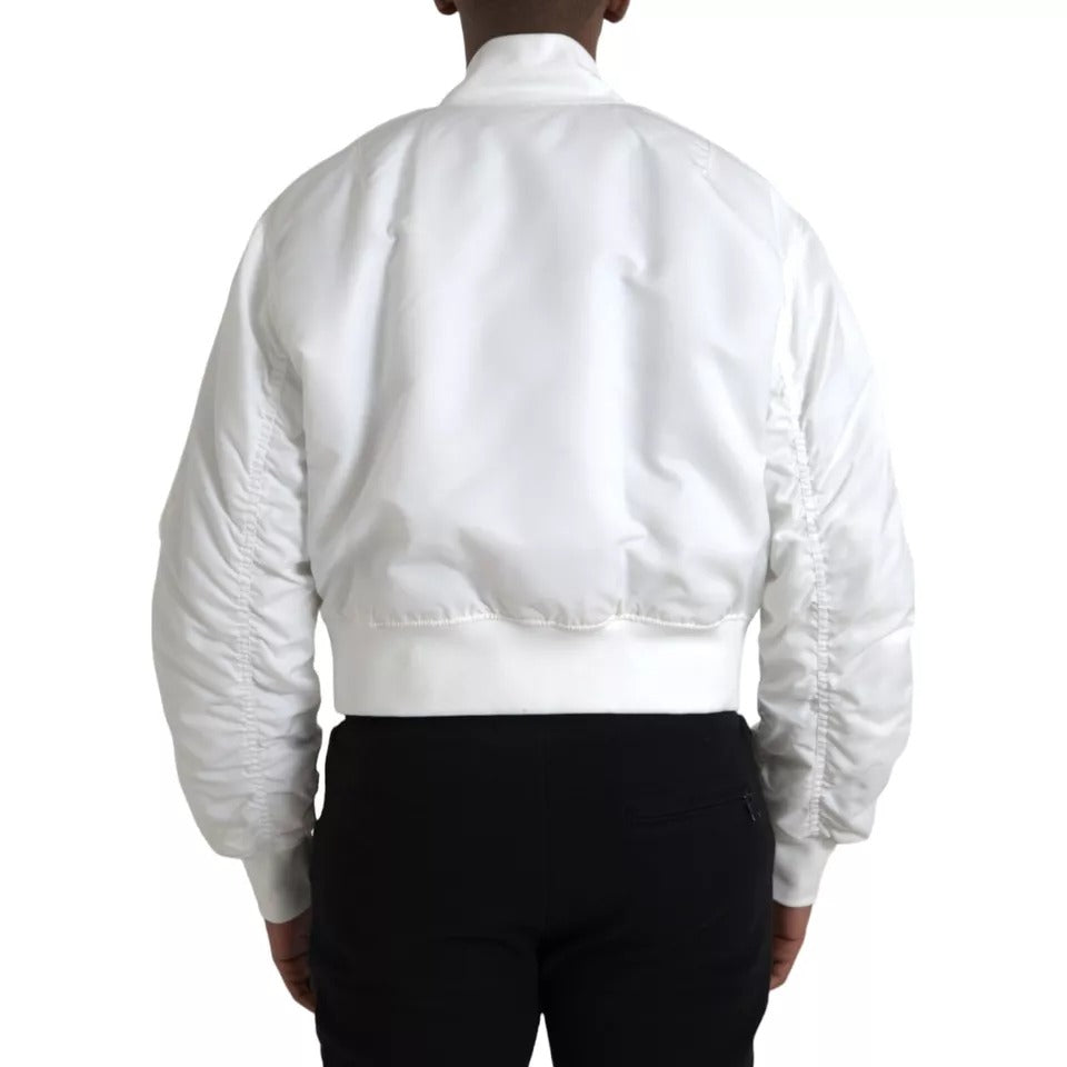 Veste bomber blanche Dolce & Gabbana à manches longues, fermeture éclair complète, style élégant et moderne.