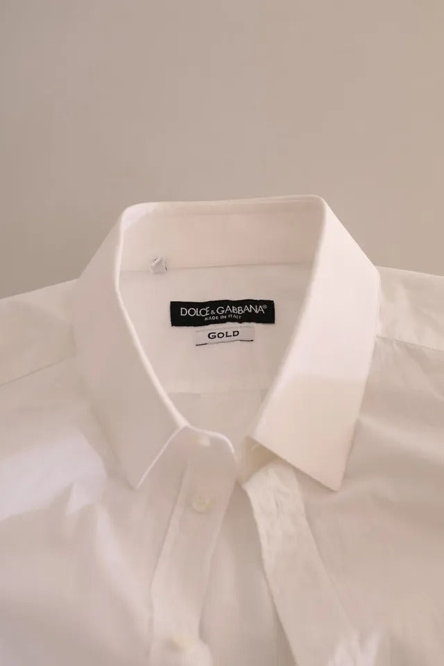 Chemise de smoking en coton blanc avec détails dorés de Dolce & Gabbana, tenue formelle élégante pour femme.