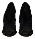 Chaussettes extensibles noires Dolce & Gabbana avec dentelle Taormina, portées avec des bottines en cuir élégantes.