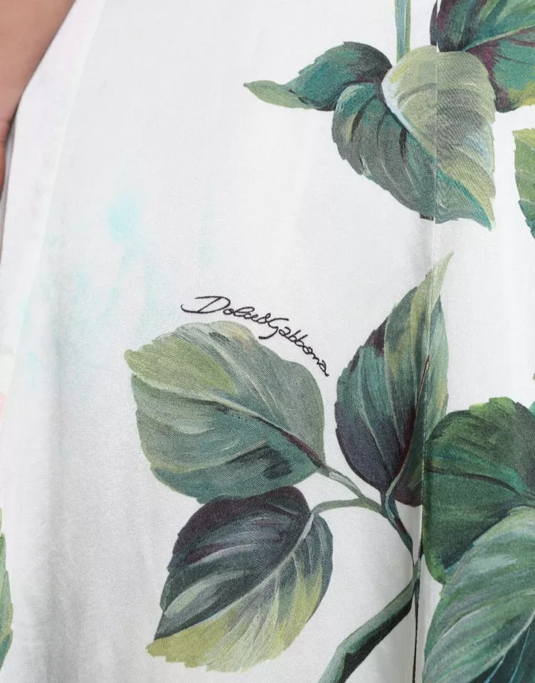 Jupe midi à taille haute Dolce & Gabbana avec imprimé de roses blanches, coupe en ligne A, tissu léger et élégant.