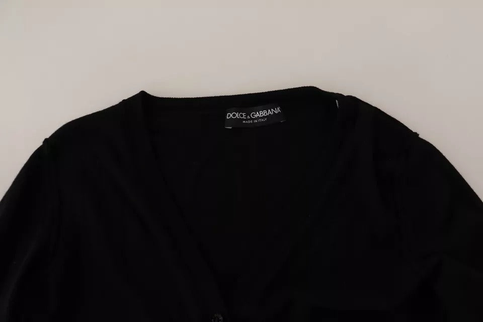 Pull en laine noir Dolce & Gabbana avec boutons, cardigan à manches longues et col en V, visible en gros plan.