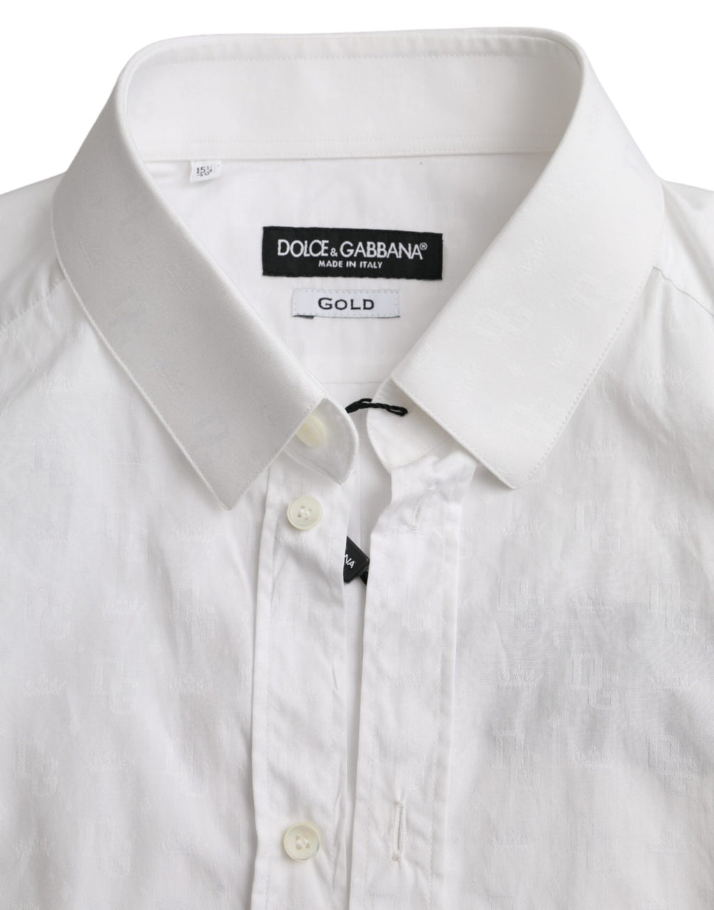 Robe en coton blanche Dolce & Gabbana à manches longues avec détails dorés, élégante et sophistiquée, vue de face.