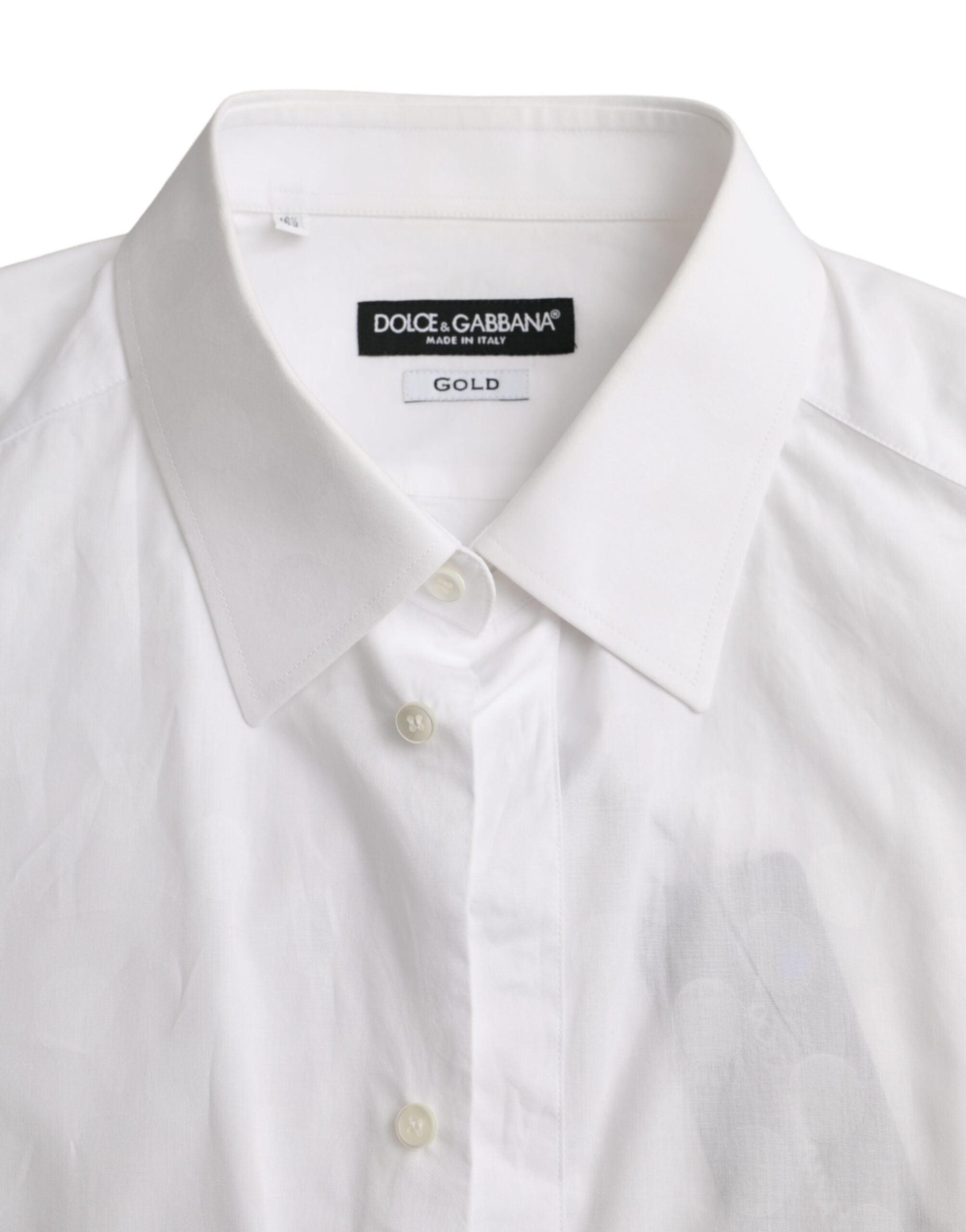 Robe en coton blanc à pois noirs et or avec détails élégants, signée Dolce & Gabbana.