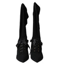 Chaussures Dolce & Gabbana, bottines noires à talons stilettos et mi-mollet, en cuir élégante et sophistiquée.