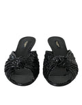 Escarpins Dolce & Gabbana en cuir exotique noir, chaussures à talons et slides élégants visibles sur l'image.